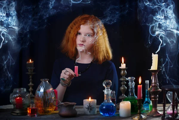 Young witch is engaged in witchcraft — Stock Photo, Image