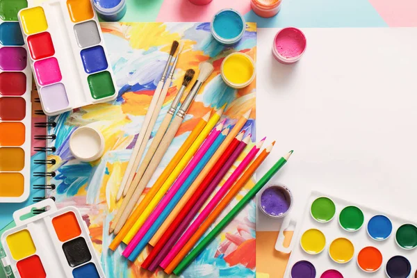 Paints, pencils and brushes on paper — Stock Photo, Image