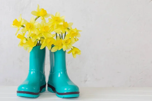 Botas de borracha e flores de primavera no fundo branco — Fotografia de Stock