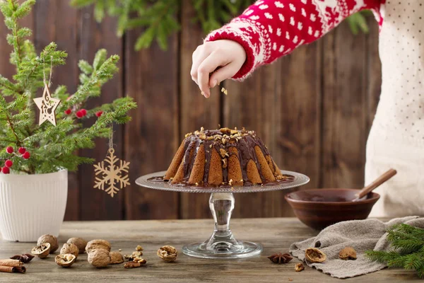 Woman cooking christmas cake on wooden kitchen — Stock Photo, Image