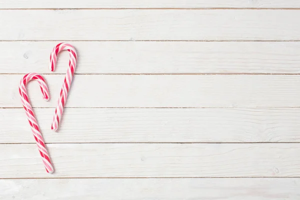 candy cane on white wooden background