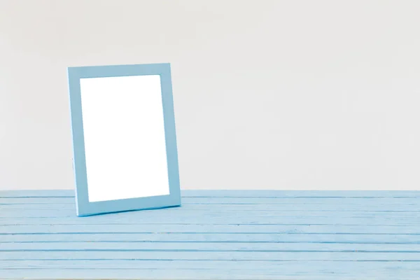 Blue wooden frame on background white wall — Stock Photo, Image