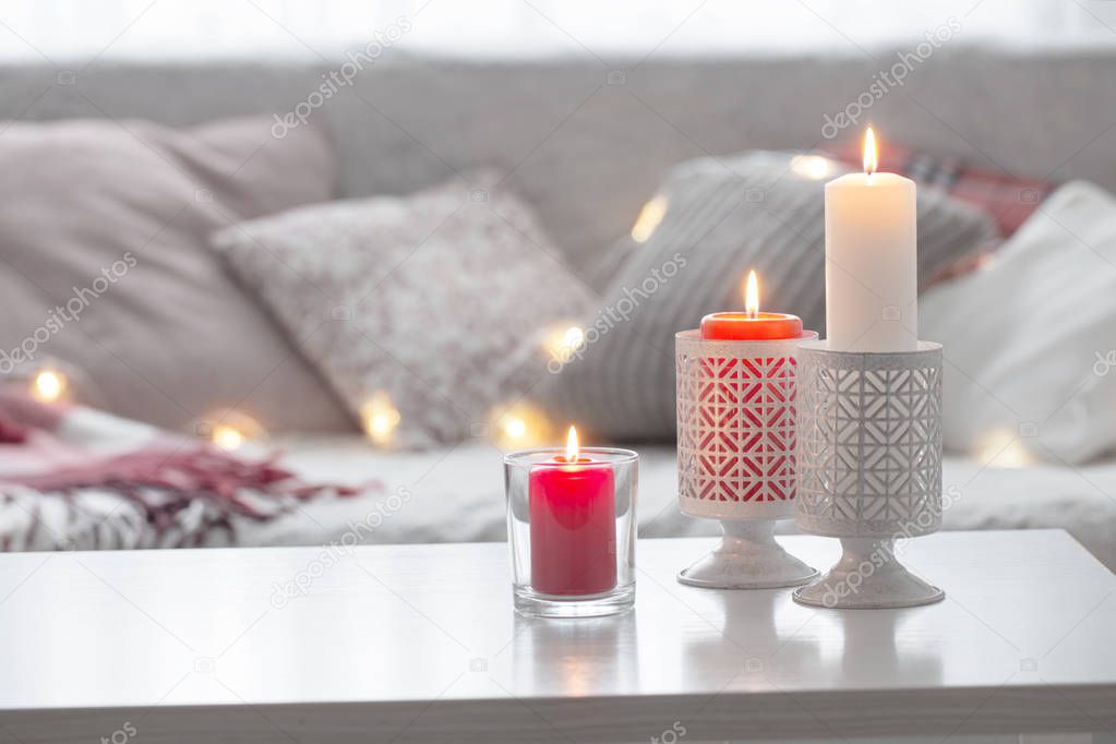 Composition of candles on  white table against the background of