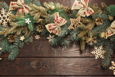 Eski, karanlık ahşap arka planda Noel dekoru olan köknar dalları 