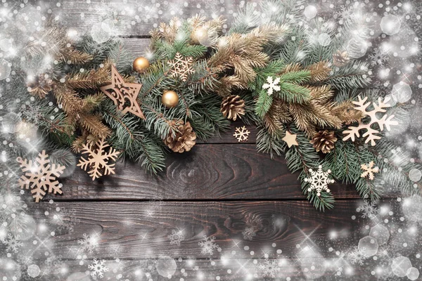 Tannenzweige mit Weihnachtsdekor auf altem dunklen Holzgrund — Stockfoto