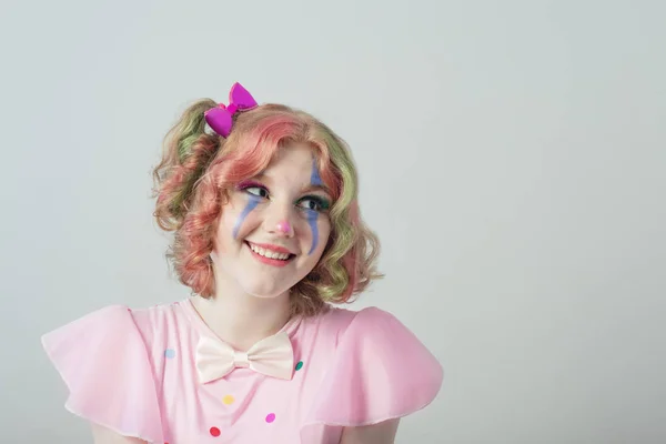 Glimlach tiener meisje in clown kostuum op witte achtergrond — Stockfoto
