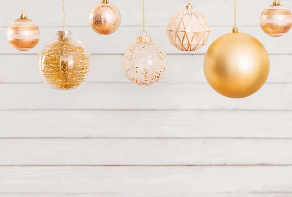 Vánoční koule visící na bílém dřevěném pozadí — Stock fotografie