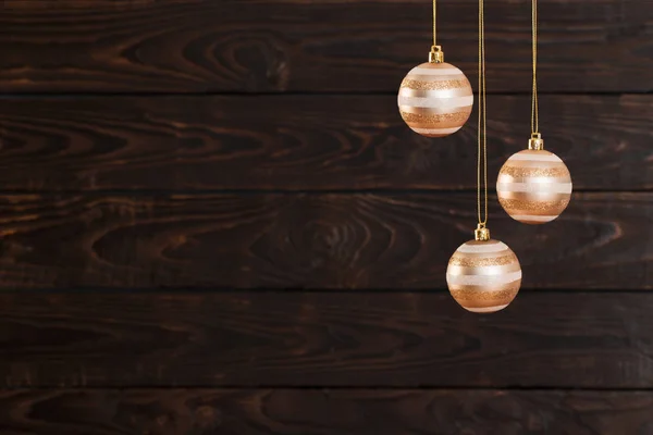 Christmas balls hanging  on  dark  wooden background — Stock Photo, Image