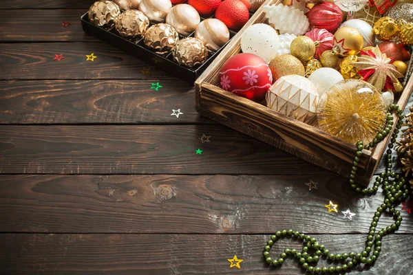 Christmas balls in box on dark wooden background — Stock Photo, Image