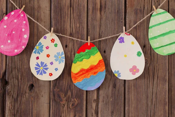 Papel Easter pintado ovos pendurados em pinos de roupa em backgr — Fotografia de Stock