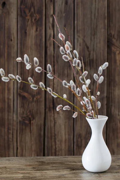 Гілки квітучої верби у вазі на дерев'яному фоні — стокове фото