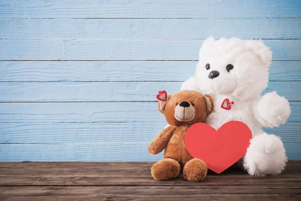 Teddybjörn med rött hjärta på gammal trä bakgrund. Alla hjärtans dag — Stockfoto