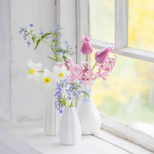 Flores de primavera en jarrón blanco en el viejo alféizar de la ventana — Foto de Stock