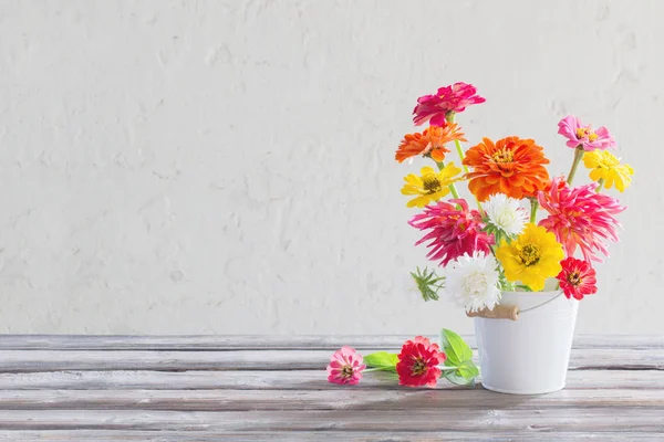Zinnia flowers in bucket on white background — Stock Photo, Image