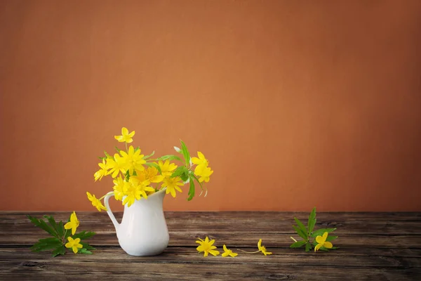 Still life with yellow spring flowers in jug — Stock Photo, Image