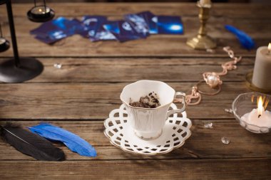 fortune-telling with  cup of coffee and fortune-telling cards on old wooden table