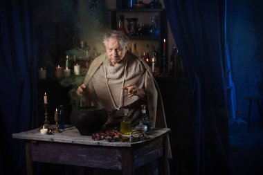 elderly alchemist monk brews  magic potion clipart