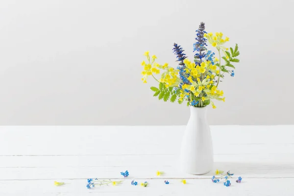 wild flowers in vase on white background