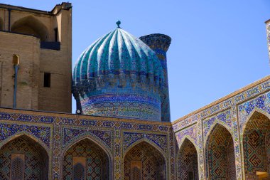 Exterior of old ancient moslem madrassah with big cupola and tiled walls in Samarkand, Uzbekistan. Central Asia travel view clipart