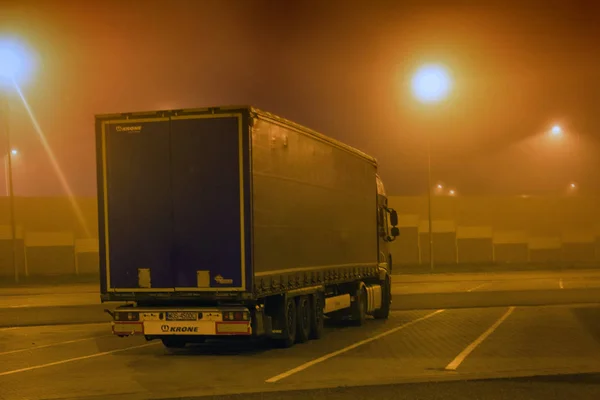 carriage of goods by road, trucking industry - overweight vehicle, foggy night road