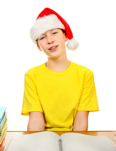 Scholier in Kerstman hoed — Stockfoto