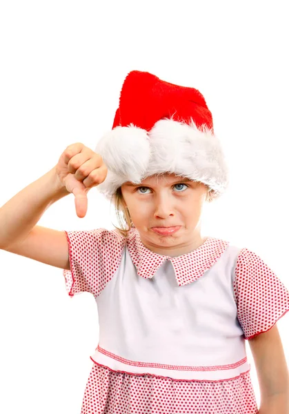 生气的小女孩，在圣诞老人的帽子 免版税图库照片