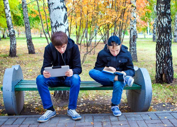 Boys reading outdoor — Stock Photo, Image