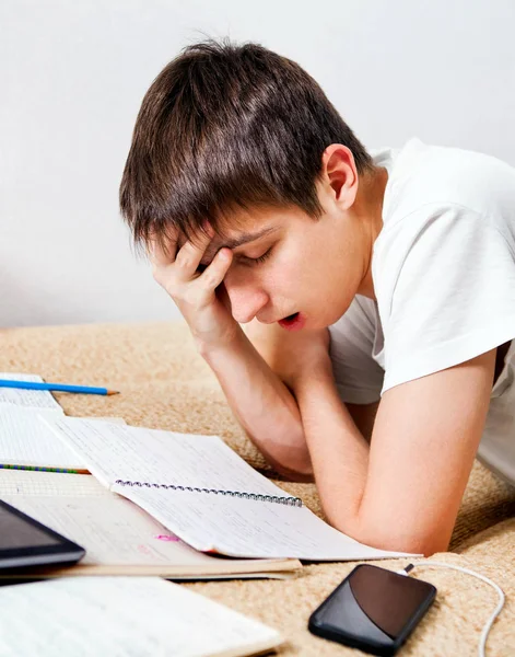 Estudante cansado fazendo lição de casa — Fotografia de Stock