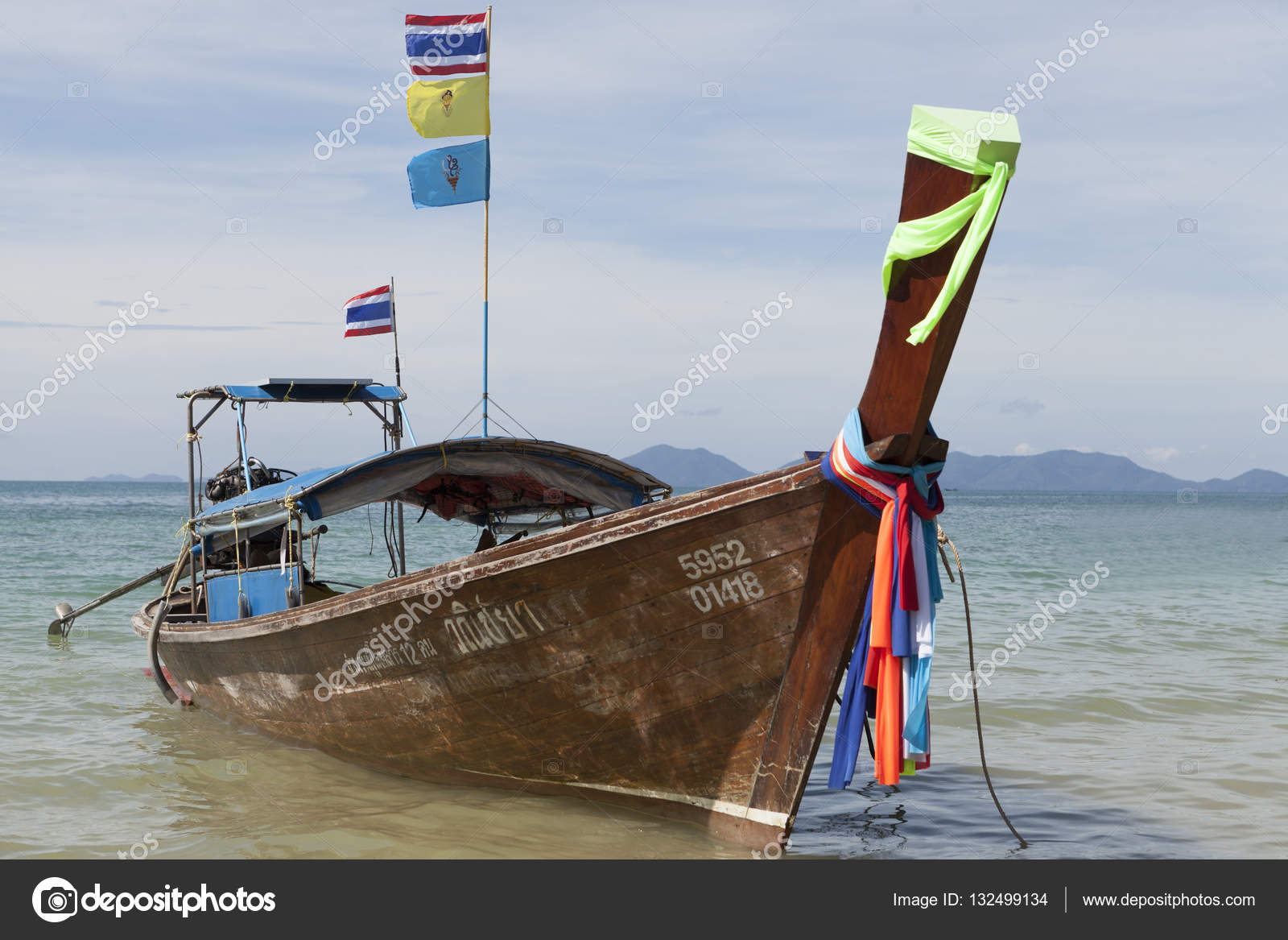 Traditional Thai Fishing boats with colorful ribbons and flags