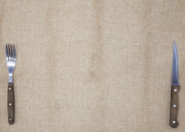 Arka plan için belgili tanımlık yemek listesi. Masa örtüsü çuval bezi, çatal, bıçak biftek ve peçete. Biftek Restoran için bir menü oluşturmak için kullanılır.