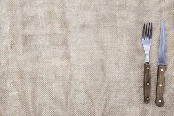 Le fond du menu. Nappe en toile et fourchette et couteau à steak. Est utilisé pour créer un menu pour un Steakhouse . — Photo