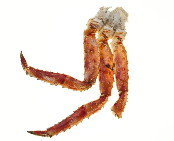 Les pattes de crabe se rapprochent sur un fond blanc. Crabe d'Extrême-Orient, une délicatesse. Groupe de crabes — Photo