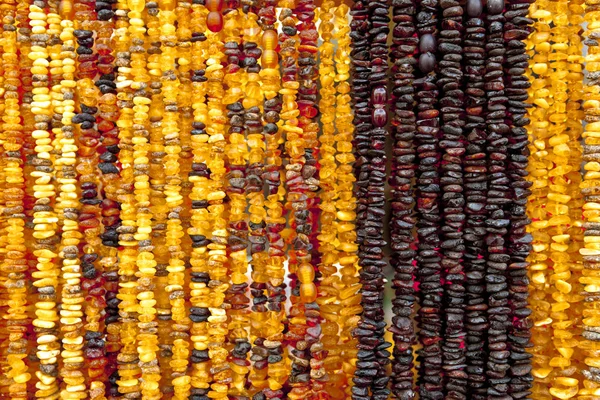 Succinite. Amber necklace. Amber of different colors and sizes. — Stock Photo, Image