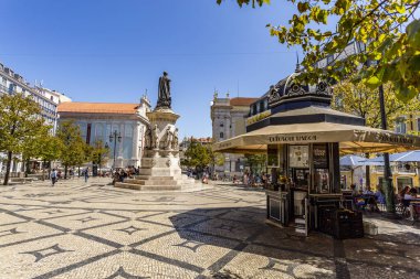 View of the Luis de Camoes Square during a sunny day, in Lisbon, the capital city of Portugal clipart