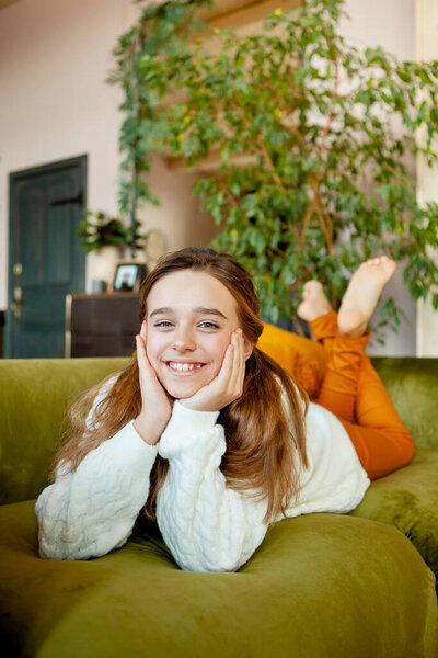 Beautiful girl sitting on a sunlit floor