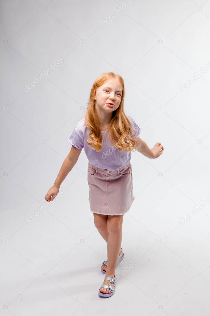 red-haired girl walks waving arms