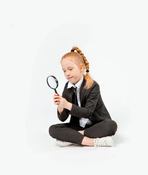 Girl Business Black Suit Sits Cross Legged Looks Magnifying Glass — Stock Photo, Image