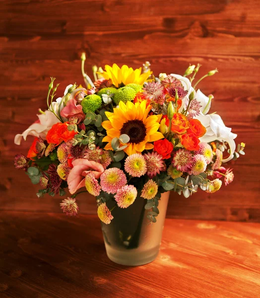 floral bouquet with lily, sunflower, chrysanthemum, eustoma (lisianthus) astrantsiya, eucalyptus, shrub rose