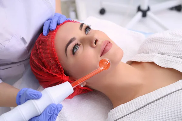 Receiving electric darsonval facial massage procedure. — Stock Photo, Image