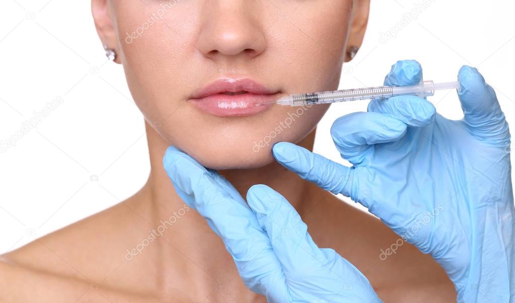 Beautiful woman gets an injection in her lips
