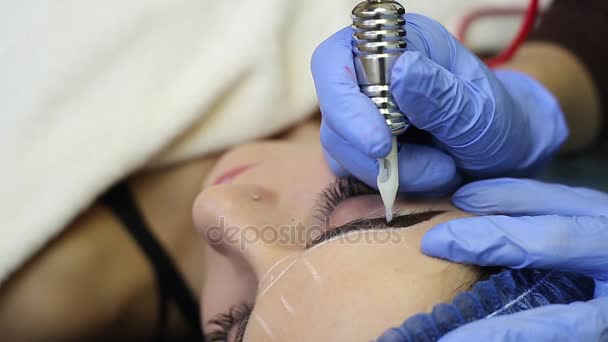 Косметолог делает постоянный макияж на лице женщины — стоковое видео