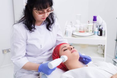 Donanım kozmetolojisi. Deriyi fırçayla temizliyor..