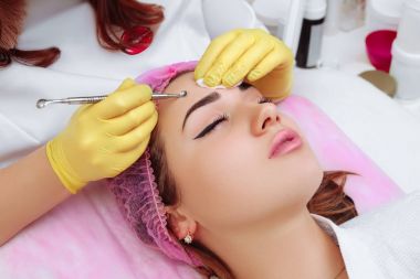 Professional cleansing of acne in a beauty salon. clipart