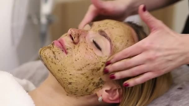 Young woman having face treatment in spa salon — Stock Video