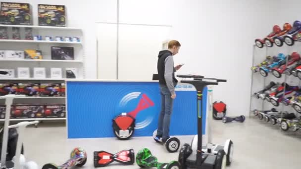 Ember test drive a gyroscooter a boltban — Stock videók