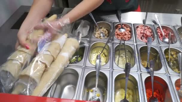 Повар готовит блюдо из ингредиентов в салат-баре — стоковое видео