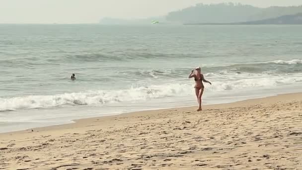 Vacker flicka spelar Frisbee på stranden — Stockvideo