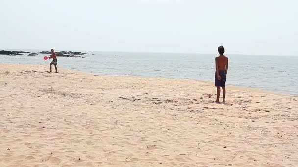 Unbekannter spielt Frisbee am Strand — Stockvideo