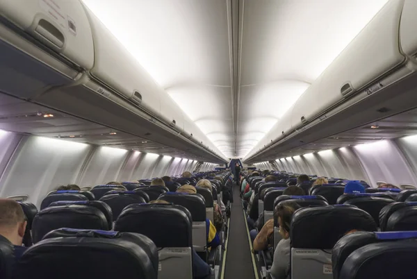 Interior of airplane with passengers on seats. — Stock Photo, Image