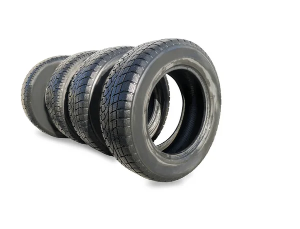 Stack of four wheel new black winter tyres for car — Stock Photo, Image